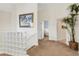 Hallway featuring carpet, glass brick wall and doorway views to a bedroom and bathroom at 1311 Triano Cir # 1311, Venice, FL 34292