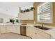 White kitchen with granite countertops and stainless steel dishwasher and sink at 1311 Triano Cir # 1311, Venice, FL 34292