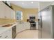 Kitchen with white cabinets, stainless steel appliances, and light yellow walls at 1311 Triano Cir # 1311, Venice, FL 34292