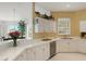 Well-lit kitchen featuring white cabinets and stainless steel appliances at 1311 Triano Cir # 1311, Venice, FL 34292