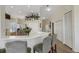 Bright kitchen with a breakfast bar that seats two, stainless steel appliances, and white cabinetry at 1311 Triano Cir # 1311, Venice, FL 34292