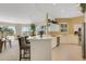 Eat-in kitchen and dining room combo with large windows, a breakfast bar, and stainless steel appliances at 1311 Triano Cir # 1311, Venice, FL 34292