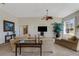 Bright living room featuring a large window, a comfortable chaise lounge, and modern entertainment setup at 1311 Triano Cir # 1311, Venice, FL 34292