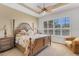Bright main bedroom with a ceiling fan, and shuttered windows that let in plenty of natural light at 1311 Triano Cir # 1311, Venice, FL 34292