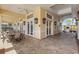 Outdoor patio with neutral furniture surrounded by double doors and beautiful hardscaping at 1311 Triano Cir # 1311, Venice, FL 34292