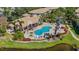 An aerial view of the community pool area with chairs and lush tropical landscaping at 1311 Triano Cir # 1311, Venice, FL 34292