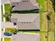 Aerial view of a well-maintained home with a landscaped backyard, a paver driveway, and lush landscaping at 14616 20Th E St, Parrish, FL 34219