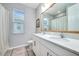 Bathroom showcasing double sinks, white cabinetry, and a well-lit space with modern fixtures at 14616 20Th E St, Parrish, FL 34219