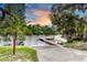 Scenic view of the community dock at sunset with palm trees and lush landscaping at 14616 20Th E St, Parrish, FL 34219