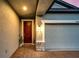Close up of the main door and garage, showcasing the brick-paved entrance and warm exterior lighting at 14616 20Th E St, Parrish, FL 34219