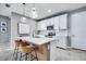 Bright kitchen featuring white cabinets, quartz countertops, modern appliances and two breakfast stools at 14616 20Th E St, Parrish, FL 34219