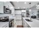 Bright kitchen with stainless steel appliances, white cabinetry, and a kitchen island at 14616 20Th E St, Parrish, FL 34219