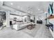 Spacious open-concept living room with a modern fireplace, neutral colors, and tiled flooring at 14616 20Th E St, Parrish, FL 34219