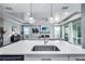Open-concept living area with a modern kitchen island and stylish pendant lighting at 14616 20Th E St, Parrish, FL 34219