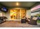 Covered patio features a grill, outdoor seating, and sliding glass doors for seamless indoor-outdoor living at 14616 20Th E St, Parrish, FL 34219
