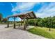 Community picnic pavilion with picnic tables and lush green landscaping in the background at 14616 20Th E St, Parrish, FL 34219