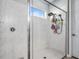 This bathroom features a glass shower, a shower head, and beautiful tile at 14616 20Th E St, Parrish, FL 34219