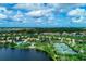 Beautiful aerial view of community, showcasing the lake, pool, and tennis courts at 1649 Burgos Dr, Sarasota, FL 34238