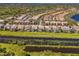 An aerial view highlights the community's well-manicured lawns and peaceful waterways at 1649 Burgos Dr, Sarasota, FL 34238