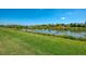 A scenic backyard offers a tranquil view of a pond at 1649 Burgos Dr, Sarasota, FL 34238