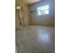 This bedroom features terrazzo flooring, neutral walls, and a window providing ample natural light at 1778 23Rd St, Sarasota, FL 34234