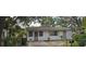 Modest single-story home featuring a cozy front yard, and natural surrounding landscaping at 1778 23Rd St, Sarasota, FL 34234