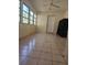 Bright sunroom with tiled floor, natural light, and ceiling fan at 1778 23Rd St, Sarasota, FL 34234