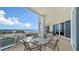 Charming balcony furnished with an outdoor dining set, perfect for enjoying meals with a view at 2050 Benjamin Franklin Dr # A1001, Sarasota, FL 34236