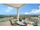 Lovely balcony furnished with an outdoor dining set, perfect for enjoying meals with stunning bay views at 2050 Benjamin Franklin Dr # A1001, Sarasota, FL 34236