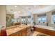 A luxurious bathroom featuring a soaking tub with water views and a spacious vanity at 2050 Benjamin Franklin Dr # A1001, Sarasota, FL 34236
