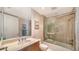 Well-lit bathroom features a marble vanity, a glass shower, and neutral tile work at 2050 Benjamin Franklin Dr # A1001, Sarasota, FL 34236