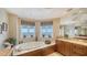 Well-lit bathroom with a soaking tub featuring waterfront views and a large vanity area at 2050 Benjamin Franklin Dr # A1001, Sarasota, FL 34236