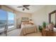 Cozy bedroom with private balcony access, comfortable furnishings, and serene waterfront views at 2050 Benjamin Franklin Dr # A1001, Sarasota, FL 34236