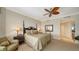 Well-appointed bedroom with a decorative ceiling fan, with bedside tables and lamps, and a large mirror at 2050 Benjamin Franklin Dr # A1001, Sarasota, FL 34236