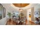 Charming dining area with a round wooden table, upholstered chairs, and stylish chandelier at 2050 Benjamin Franklin Dr # A1001, Sarasota, FL 34236