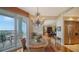Elegant dining area with a unique chandelier and access to a balcony with beautiful views at 2050 Benjamin Franklin Dr # A1001, Sarasota, FL 34236