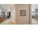 Elegant hallway with hardwood floors, a framed print, and access to the bathroom at 2050 Benjamin Franklin Dr # A1001, Sarasota, FL 34236