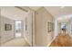 A pristine hallway shows the transition between carpeted and hardwood flooring at 2050 Benjamin Franklin Dr # A1001, Sarasota, FL 34236