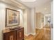 Hallway view featuring hardwood floors, neutral walls, and elegant decor leading to other rooms in the residence at 2050 Benjamin Franklin Dr # A1001, Sarasota, FL 34236
