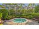 Inviting jacuzzi tub surrounded by greenery and tropical landscaping for relaxation and privacy at 2050 Benjamin Franklin Dr # A1001, Sarasota, FL 34236