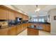 Spacious kitchen featuring wooden cabinetry, granite countertops, and a center island with bar seating at 2050 Benjamin Franklin Dr # A1001, Sarasota, FL 34236