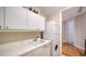 Bright laundry room featuring a sink, ample cabinet space, and stacked washer and dryer for efficient use of space at 2050 Benjamin Franklin Dr # A1001, Sarasota, FL 34236