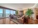 Elegant living room with hardwood floors, floor-to-ceiling windows, and a balcony overlooking the water at 2050 Benjamin Franklin Dr # A1001, Sarasota, FL 34236