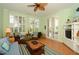 Inviting living room with plush seating, tropical fan, and bright natural light from shuttered windows at 2050 Benjamin Franklin Dr # A1001, Sarasota, FL 34236