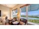 Cozy sitting area featuring two leather chairs overlooking peaceful water views at 2050 Benjamin Franklin Dr # A1001, Sarasota, FL 34236