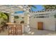 Outdoor patio with white pergola, bar, seating and outdoor kitchen at 2050 Benjamin Franklin Dr # A1001, Sarasota, FL 34236
