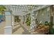 Inviting pergola seating area surrounded by lush tropical landscaping providing shade and peaceful relaxation at 2050 Benjamin Franklin Dr # A1001, Sarasota, FL 34236