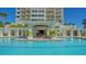 Stunning pool area at building's entrance with lounge area in the pool and lush landscaping at 2050 Benjamin Franklin Dr # A1001, Sarasota, FL 34236