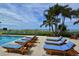 Relaxing pool with ocean view and palm trees providing a perfect outdoor retreat to relax and enjoy at 2050 Benjamin Franklin Dr # A1001, Sarasota, FL 34236