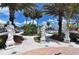 Charming street view featuring classic statues and lush palm trees at 2050 Benjamin Franklin Dr # A1001, Sarasota, FL 34236